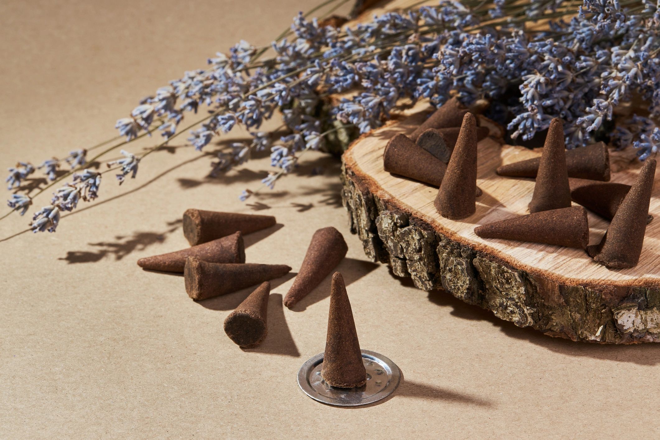 Burning incense cones with floral accents